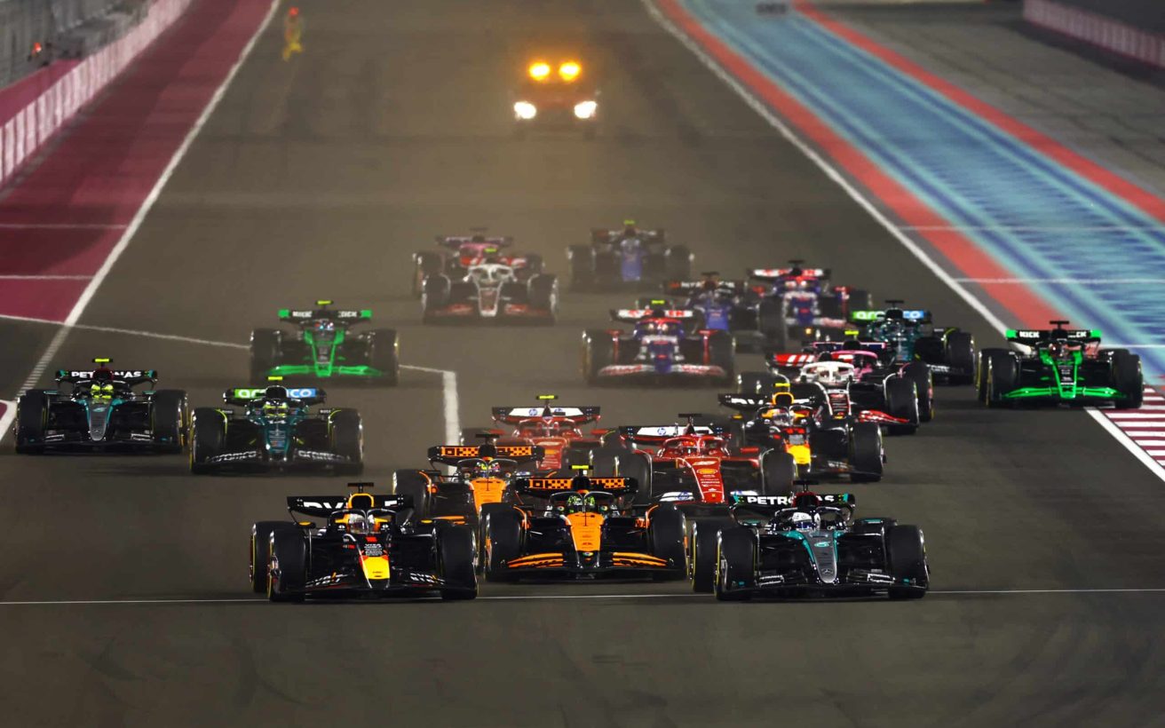 LUSAIL CITY, QATAR - DECEMBER 01: George Russell of Great Britain driving the (63) Mercedes AMG Petronas F1 Team W15 and Max Verstappen of the Netherlands driving the (1) Oracle Red Bull Racing RB20 lead the field into turn 1 at the start during the F1 Grand Prix of Qatar at Lusail International Circuit on December 01, 2024 in Lusail City, Qatar. (Photo by Mark Thompson/Getty Images) // Getty Images / Red Bull Content Pool // SI202412010398 // Usage for editorial use only //