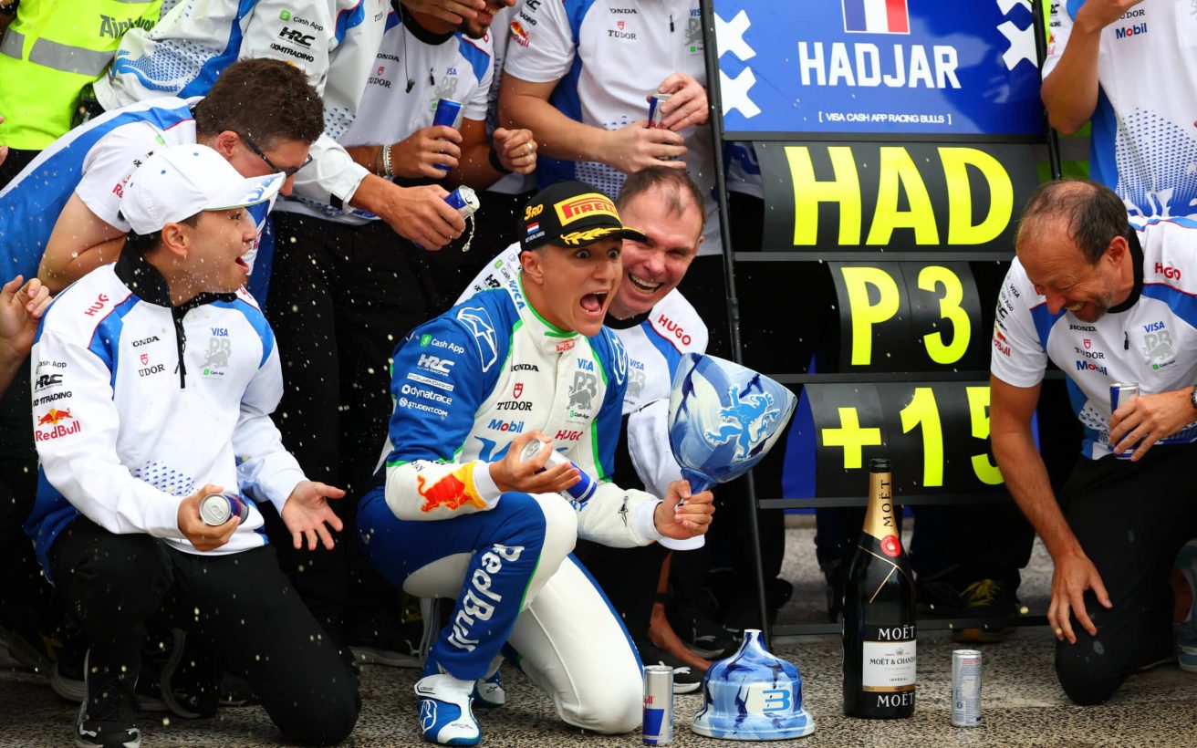 ZANDVOORT, NETHERLANDS - AUGUST 31: Third placed Isack Hadjar of France and Visa Cash App Racing Bulls Alan Permane, Team Principal of Visa Cash App Racing Bulls Peter Bayer, CEO of Visa Cash App Racing Bulls and the Visa Cash App Racing Bulls team celebrate during the F1 Grand Prix of Netherlands at Circuit Zandvoort on August 31, 2025 in Zandvoort, Netherlands. (Photo by Clive Rose/Getty Images) // Getty Images / Red Bull Content Pool // SI202508310547 // Usage for editorial use only //