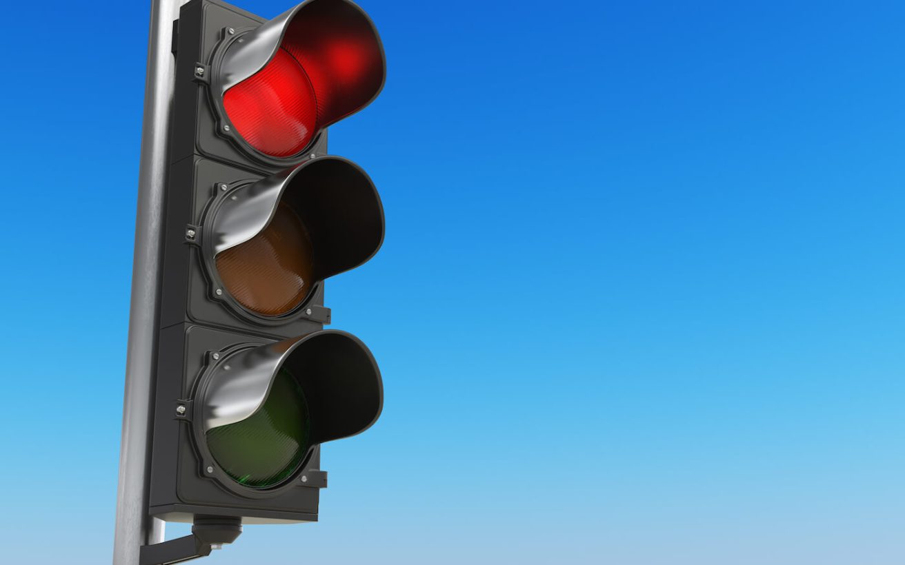 Traffic light with red color on blue sky background. Stop concept. 3d illustration